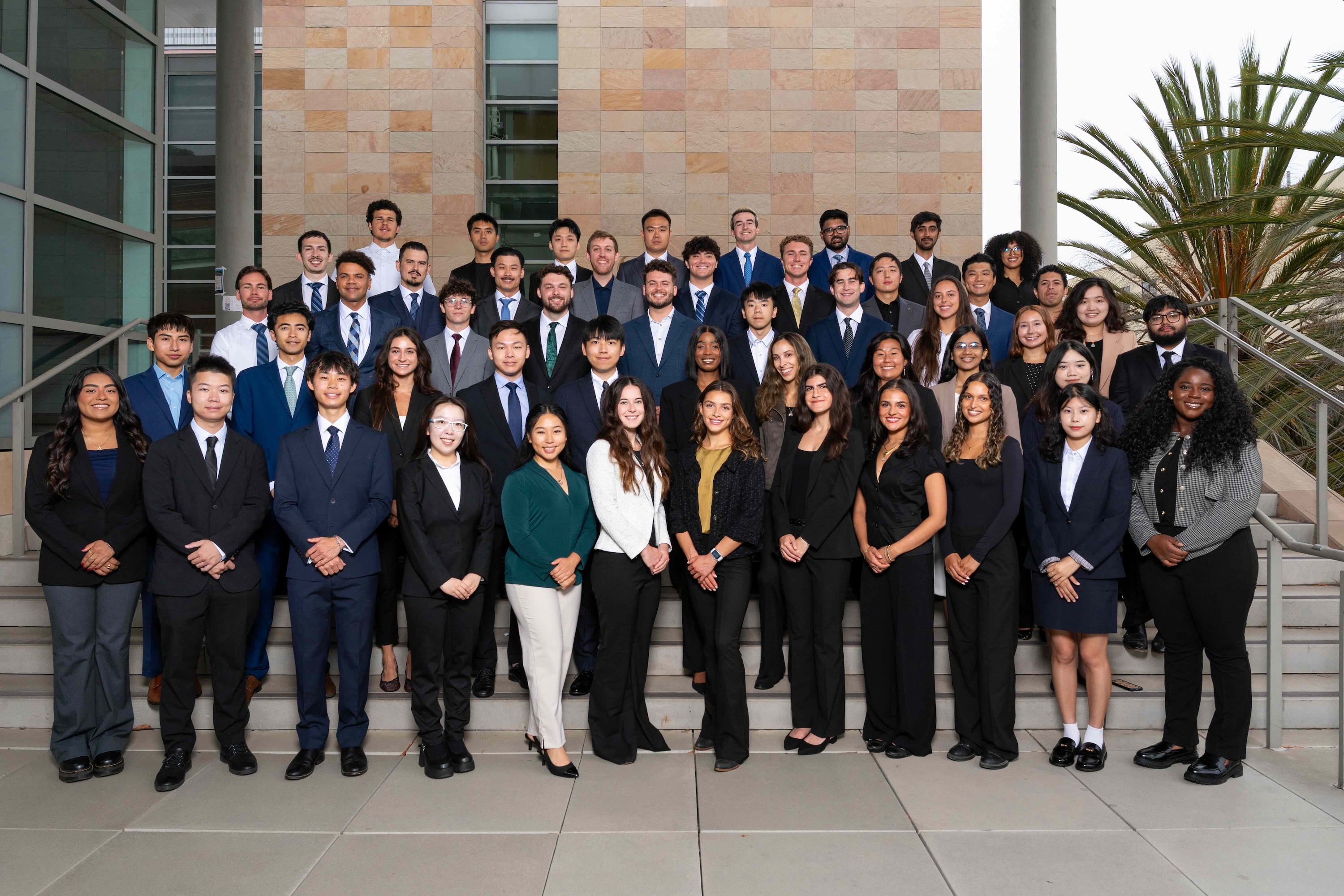 A group photo of the MTM Class of 2026 in professional attire. 