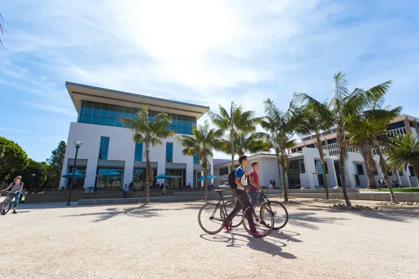 students riding bikes across campus