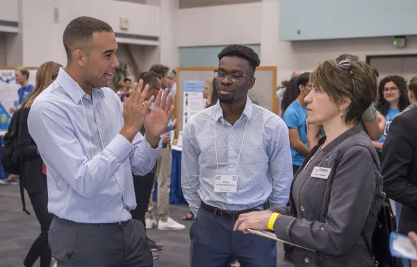 faculty offering feedback on student business pitch