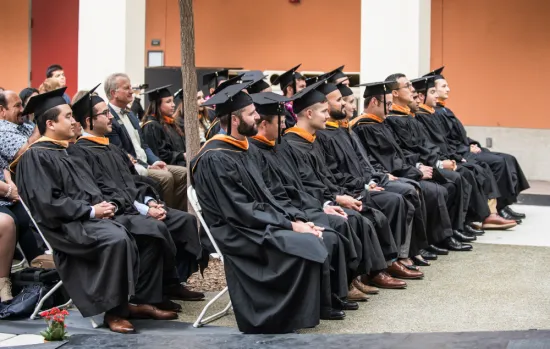 the MTM graduates sit and listen to the welcome remarks by MTM professor paul leonardi
