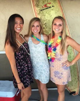 kelly with two other girls wearing lei's and summery dresses