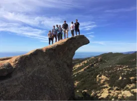 photo of the seven students on a cliff