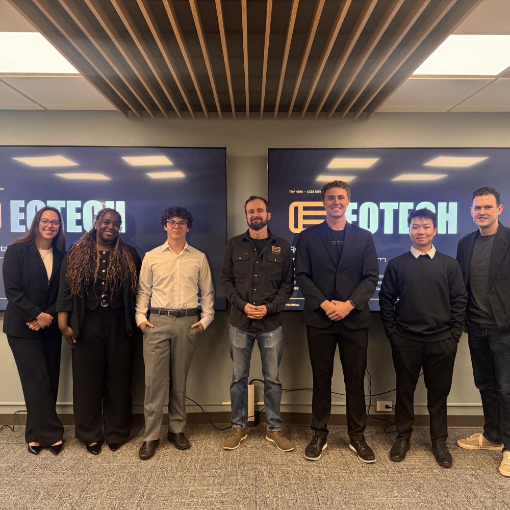 A photo of Paul Malone and MTM students in front of an Eotech presentation