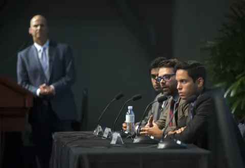 three UCSB students on a panel looking seriously at the crowd