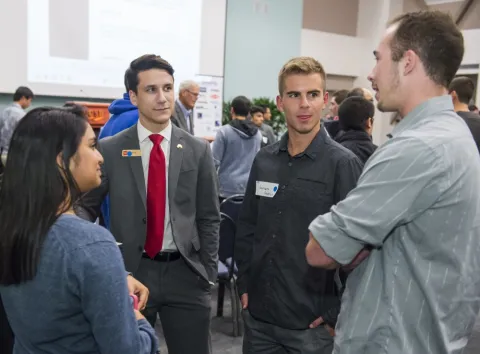 students talking to mentors at the NVC Elevator Pitch social