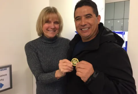 Sally Vita and Jesus Gama with Natl Guard coin given to show theri appreciation of service to their unit