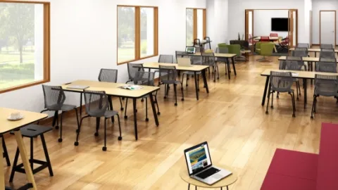 photo of a classroom devoid of students and filled with desks and chairs