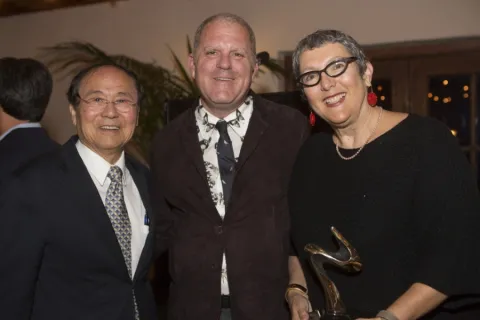 venky awards linda weinman stands with two other men