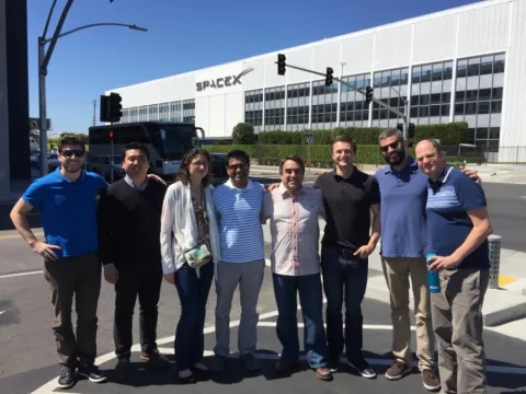 photo of a group of students gathered in front of the main spacex building