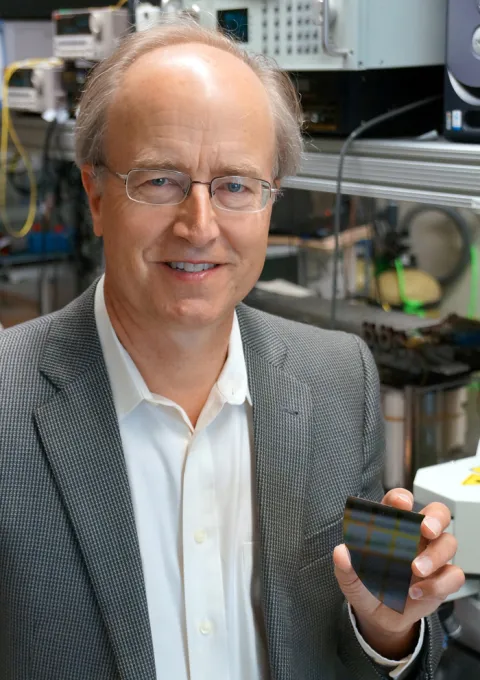 photo of professor john bowers holding a geometric black object