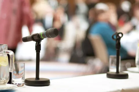 stock photo of a mic on top of a table for a panel
