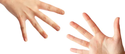 stock photo of two hands reaching out for one another