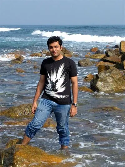 photo of Siddharth standing in the shallow ocean